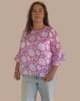 Casual pink top with a floral pattern, ideal for a laid-back, feminine look.