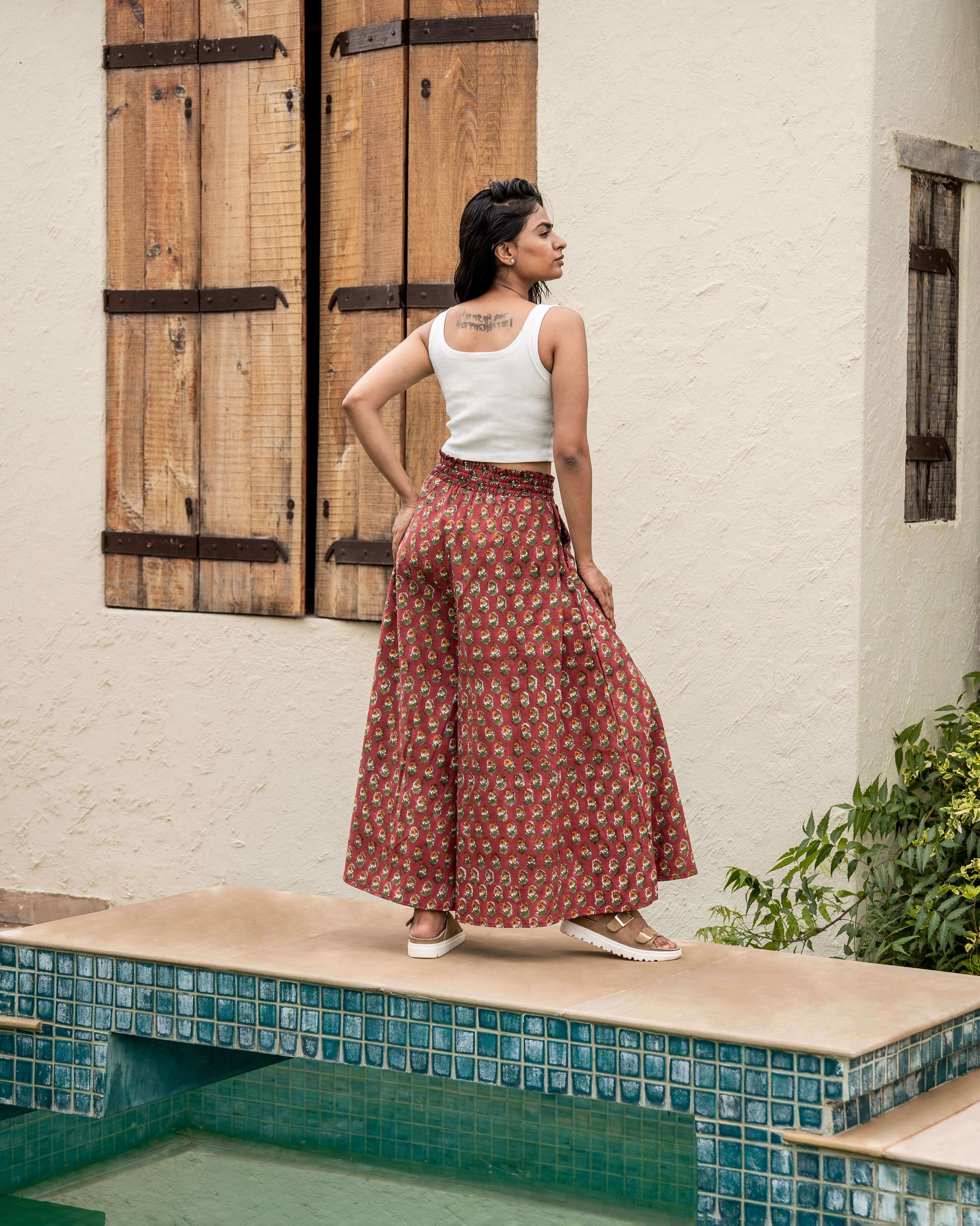 Stylish red floral wide leg pants designed for comfort, featuring an elastic waist and graceful flared legs, ideal for any casual outing.