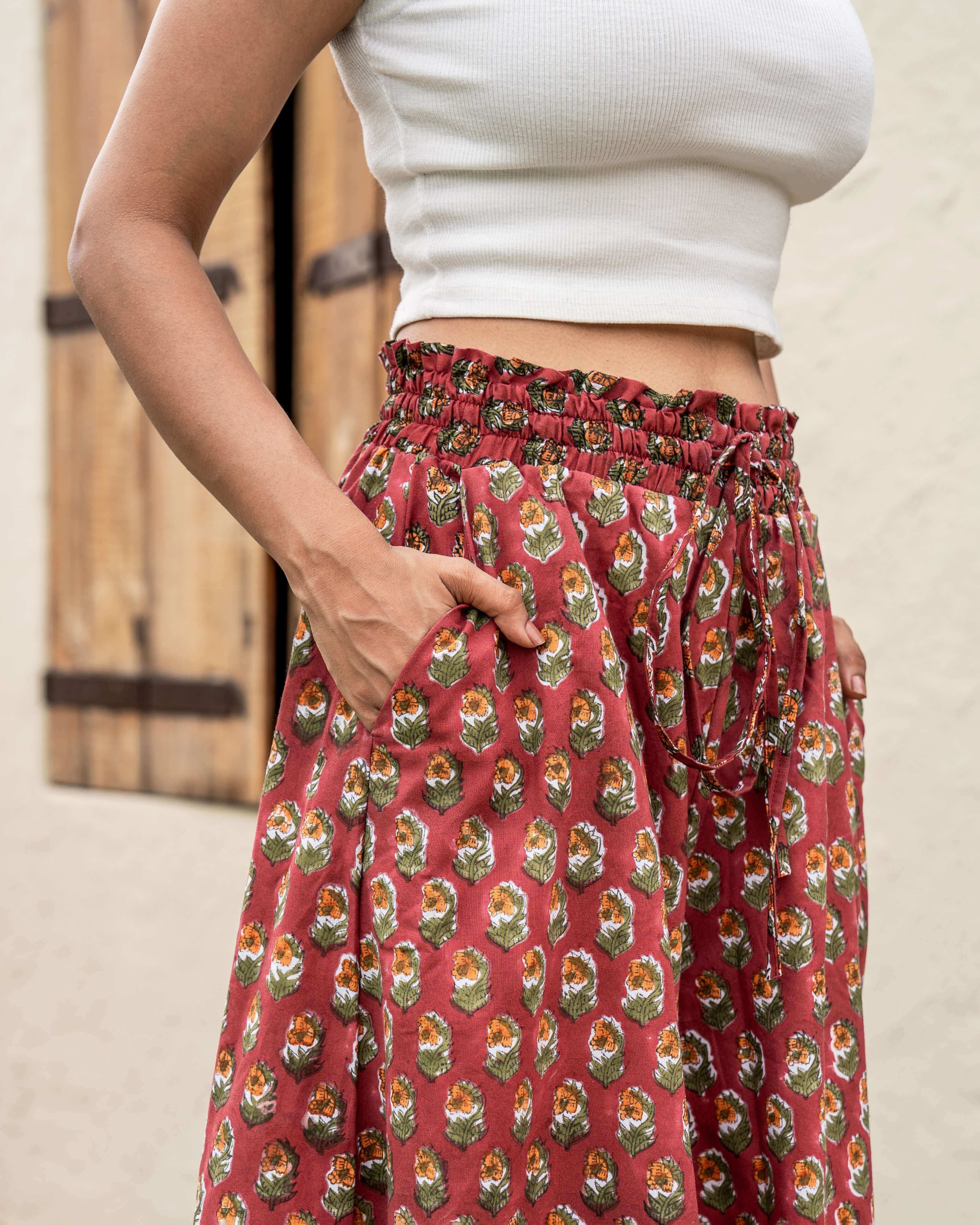 Unique red floral wide leg pants, hand-block printed for a striking look, with a comfy elastic waist and pockets for everyday convenience.