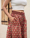 Unique red floral wide leg pants, hand-block printed for a striking look, with a comfy elastic waist and pockets for everyday convenience.