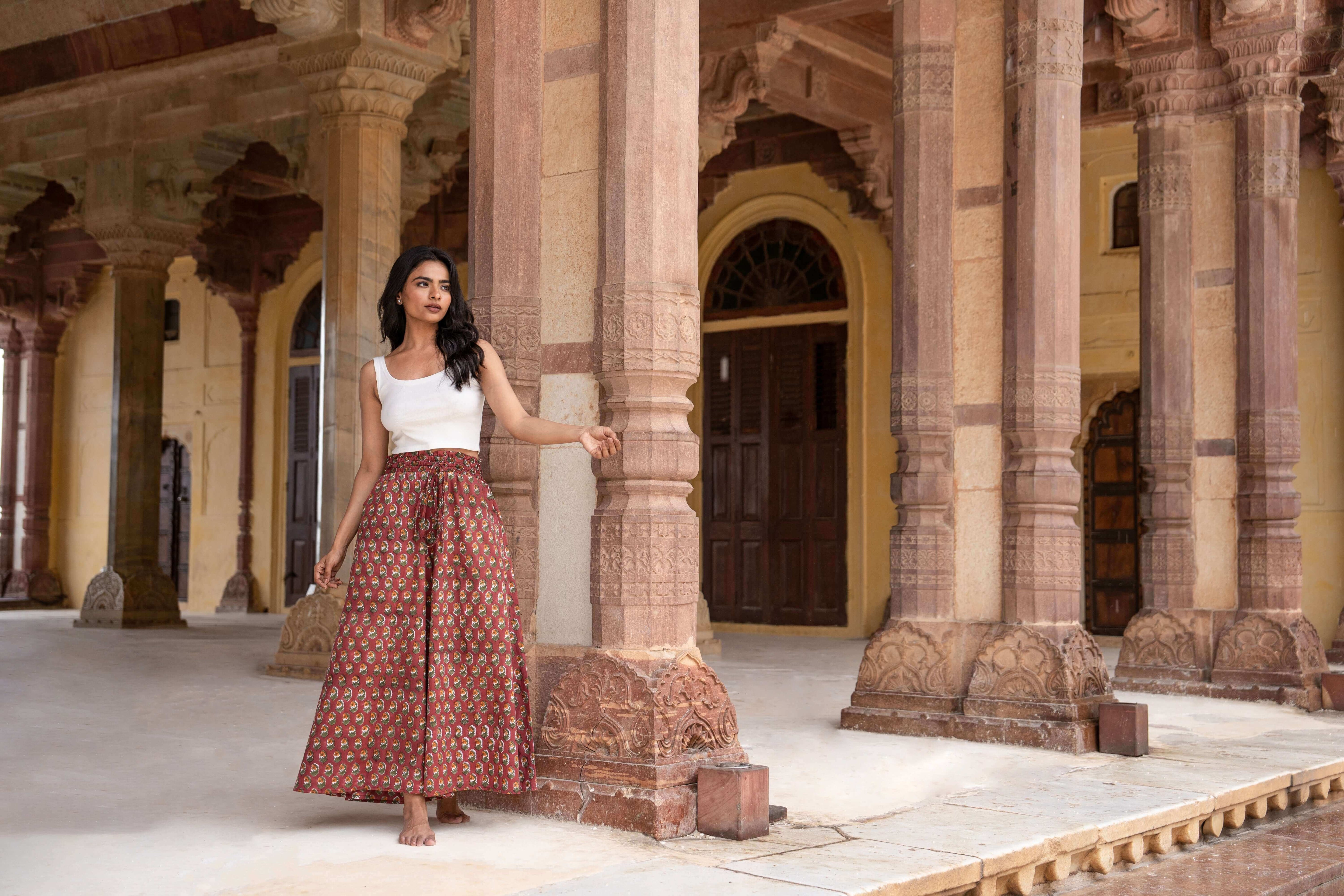 Timeless red floral wide leg pants with flared legs and practical pockets, offering both style and functionality for any occasion.