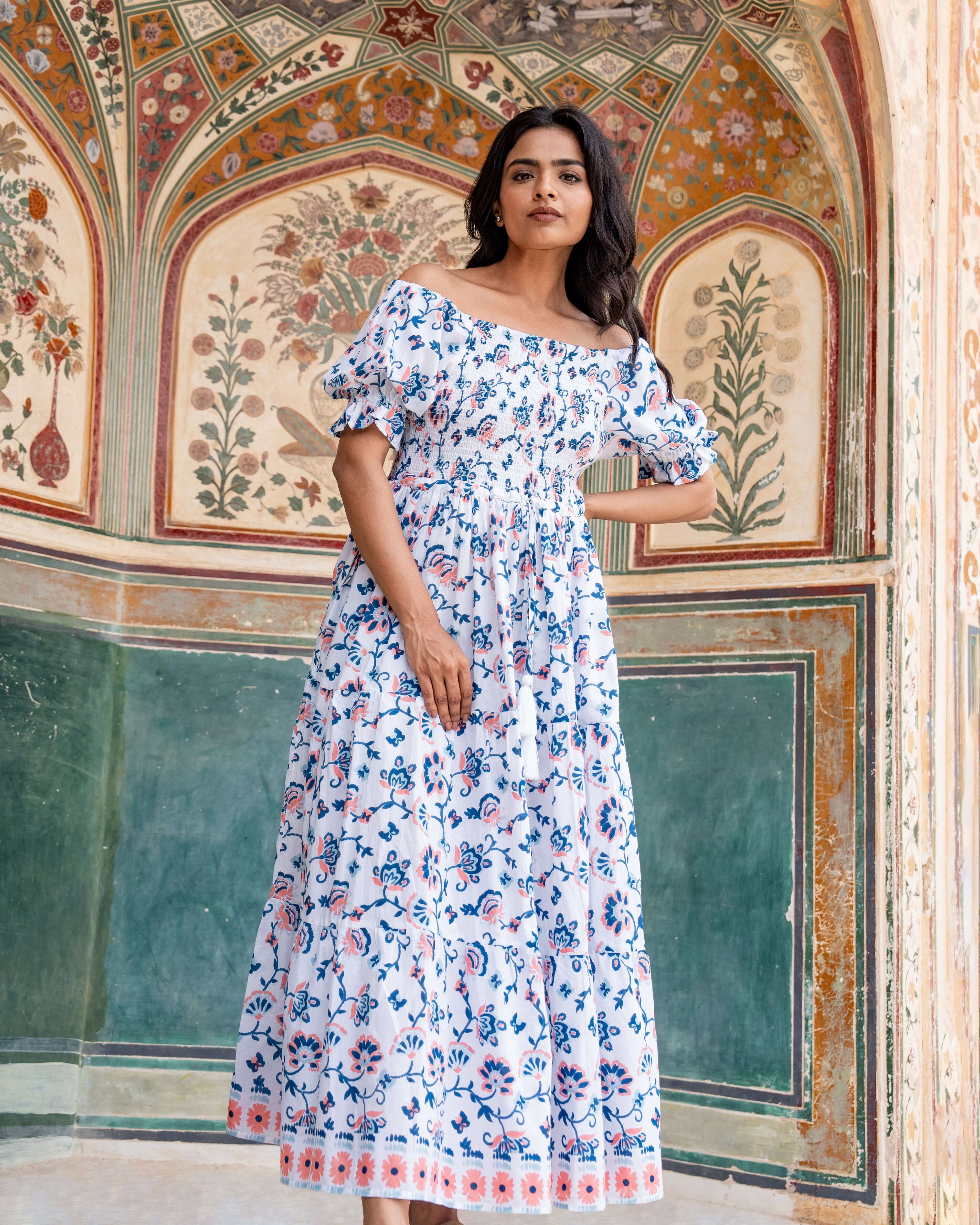 Handcrafted blue and orange floral maxi dress with a shirred design, relaxed fit, and practical side pockets for timeless elegance and comfort.