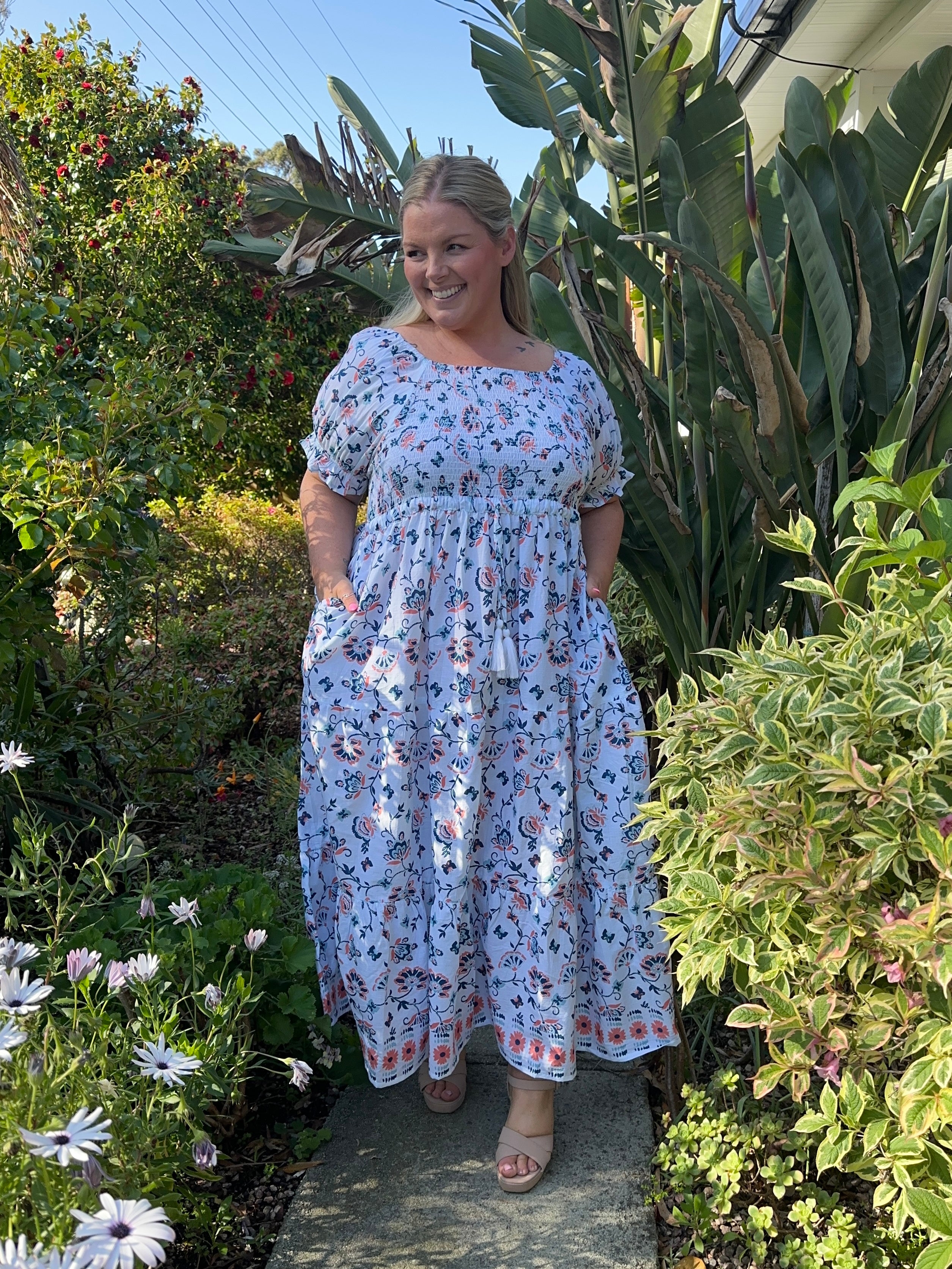 Elegant blue maxi dress with a shirred top and flowing skirt, perfect for summer occasions