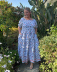 Elegant blue maxi dress with a shirred top and flowing skirt, perfect for summer occasions