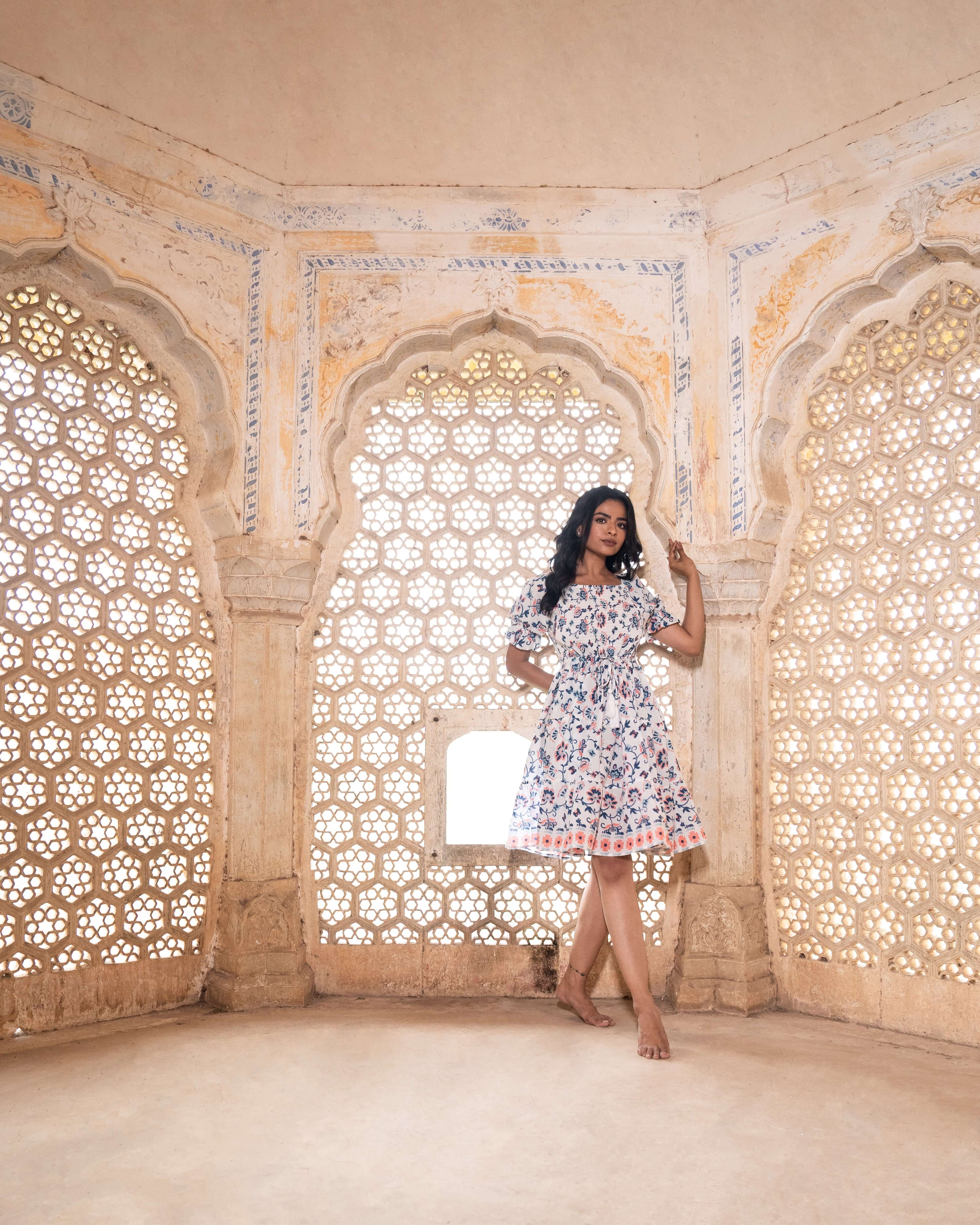 Gorgeous cotton midi dress with enchanting blue and peach floral prints, featuring a flattering shirred top and relaxed silhouette for effortless wear.