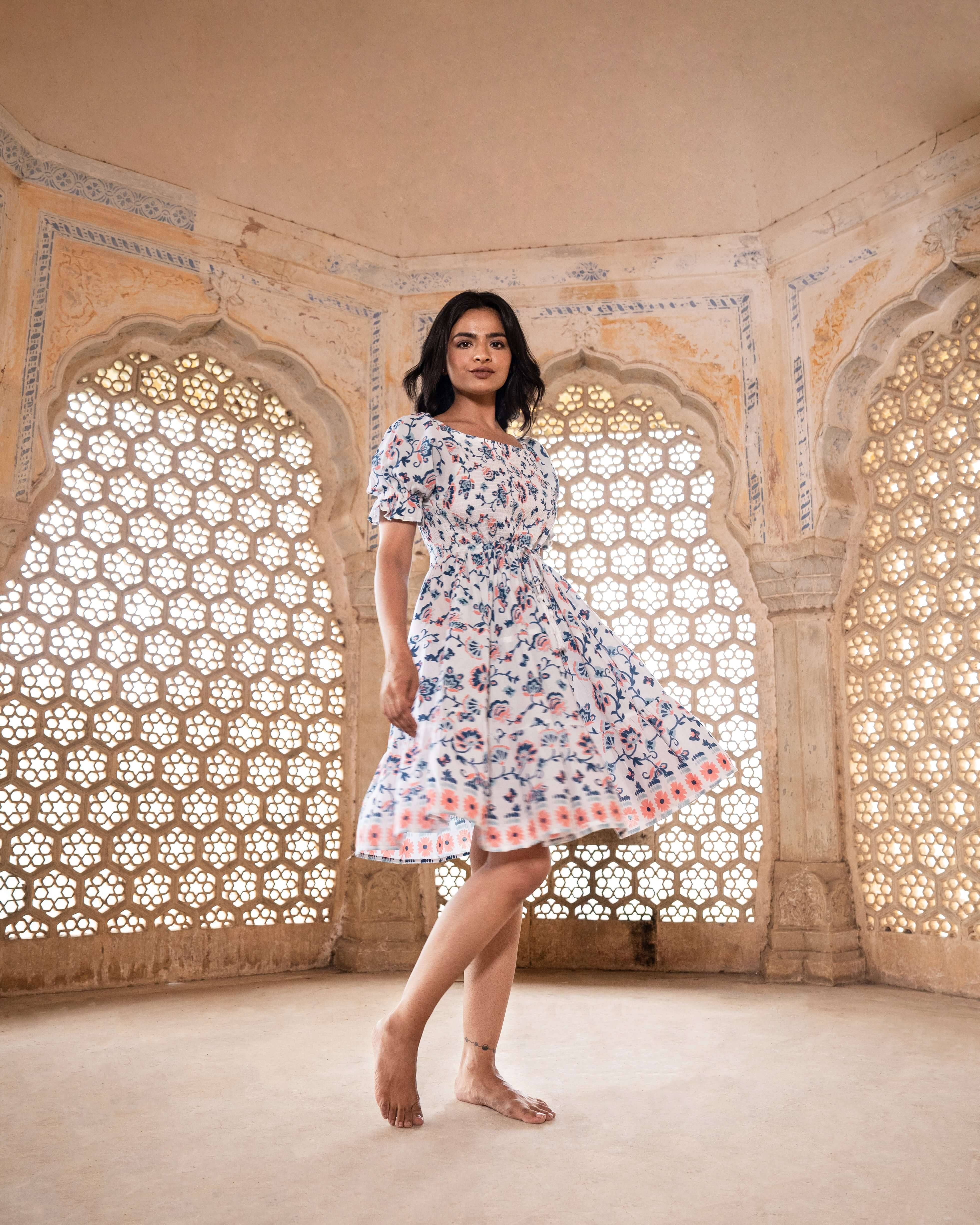 Versatile blue and peach floral midi dress over white, showcasing a stylish shirred chest and elastic sleeves, ideal for any occasion.