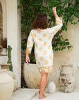 Elevate your style with our yellow floral short dress. Embrace elegance with ease.