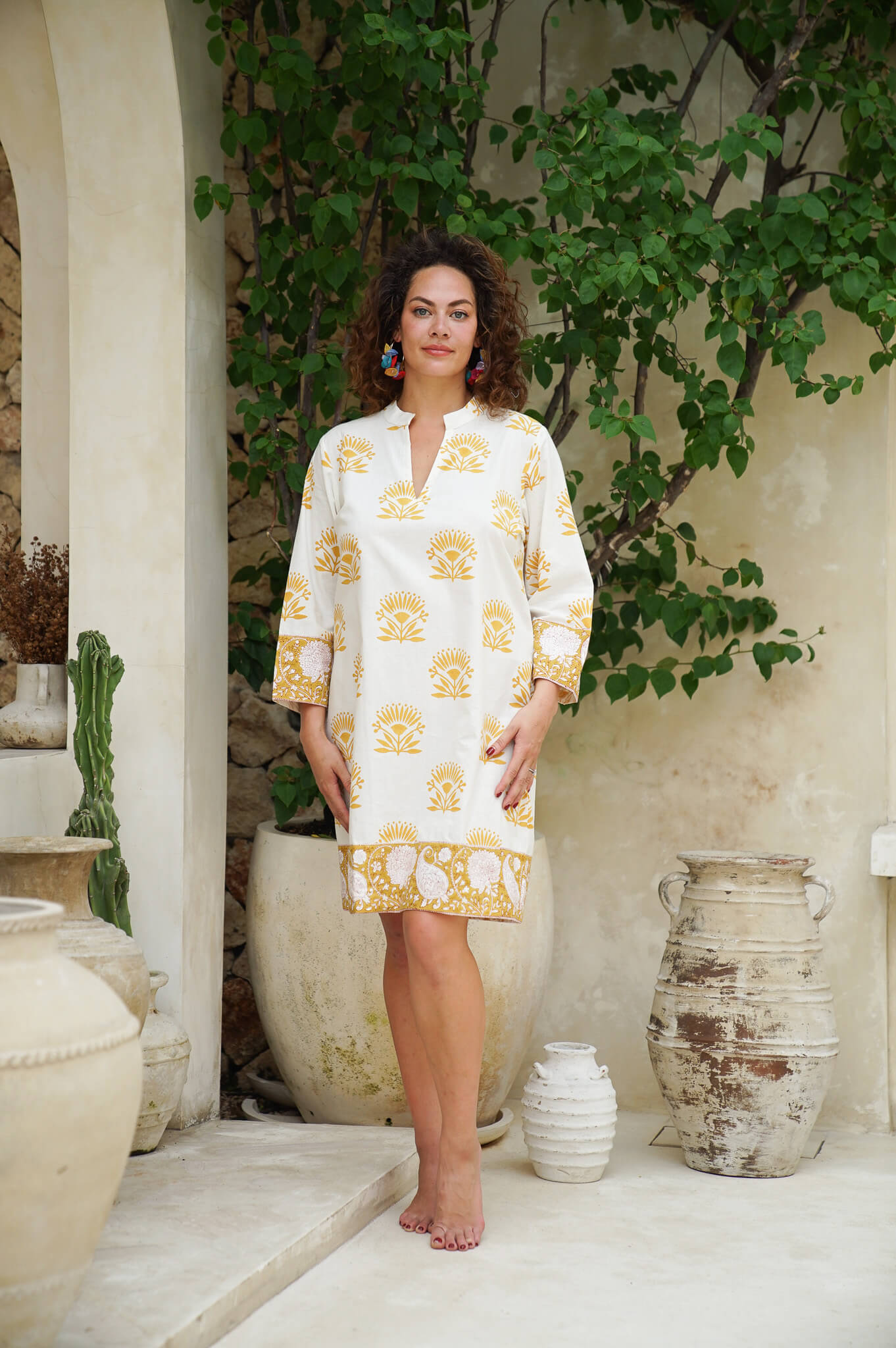 Elevate your style with our yellow floral short dress. Embrace elegance with ease.