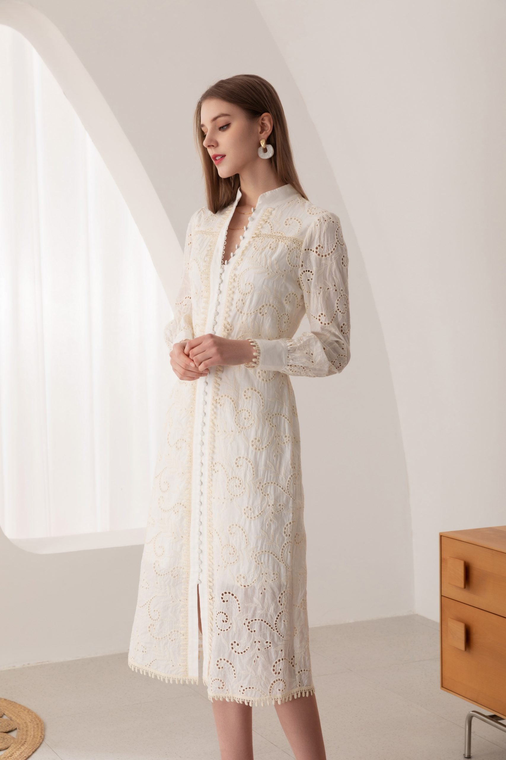 Discover timeless beauty in our Embroidered White Cotton Midi Dress. Embrace sophistication with every step.