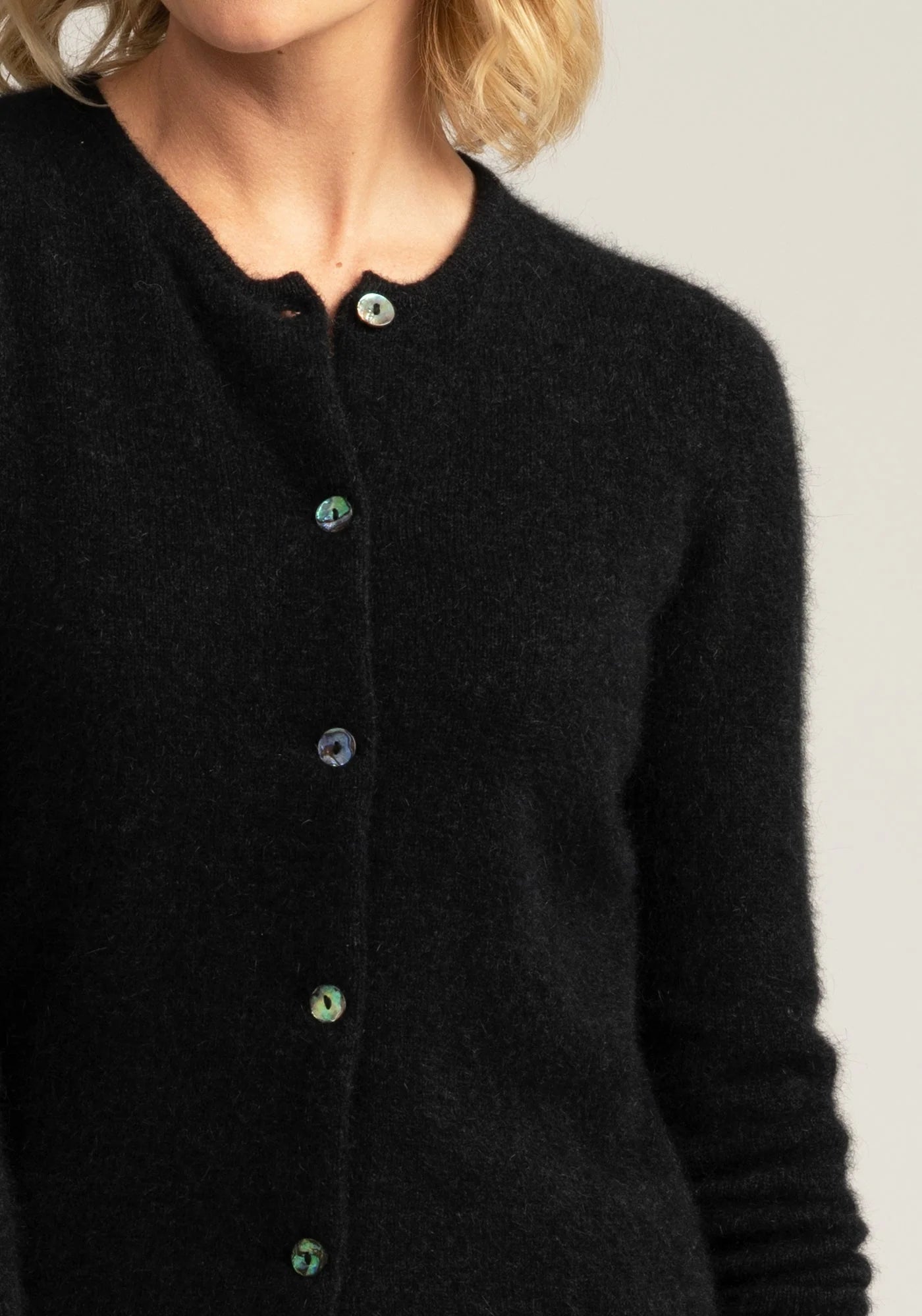 "Elevate your wardrobe with our black merino wool button-up cardigan. Unmatched comfort and elegance await!"