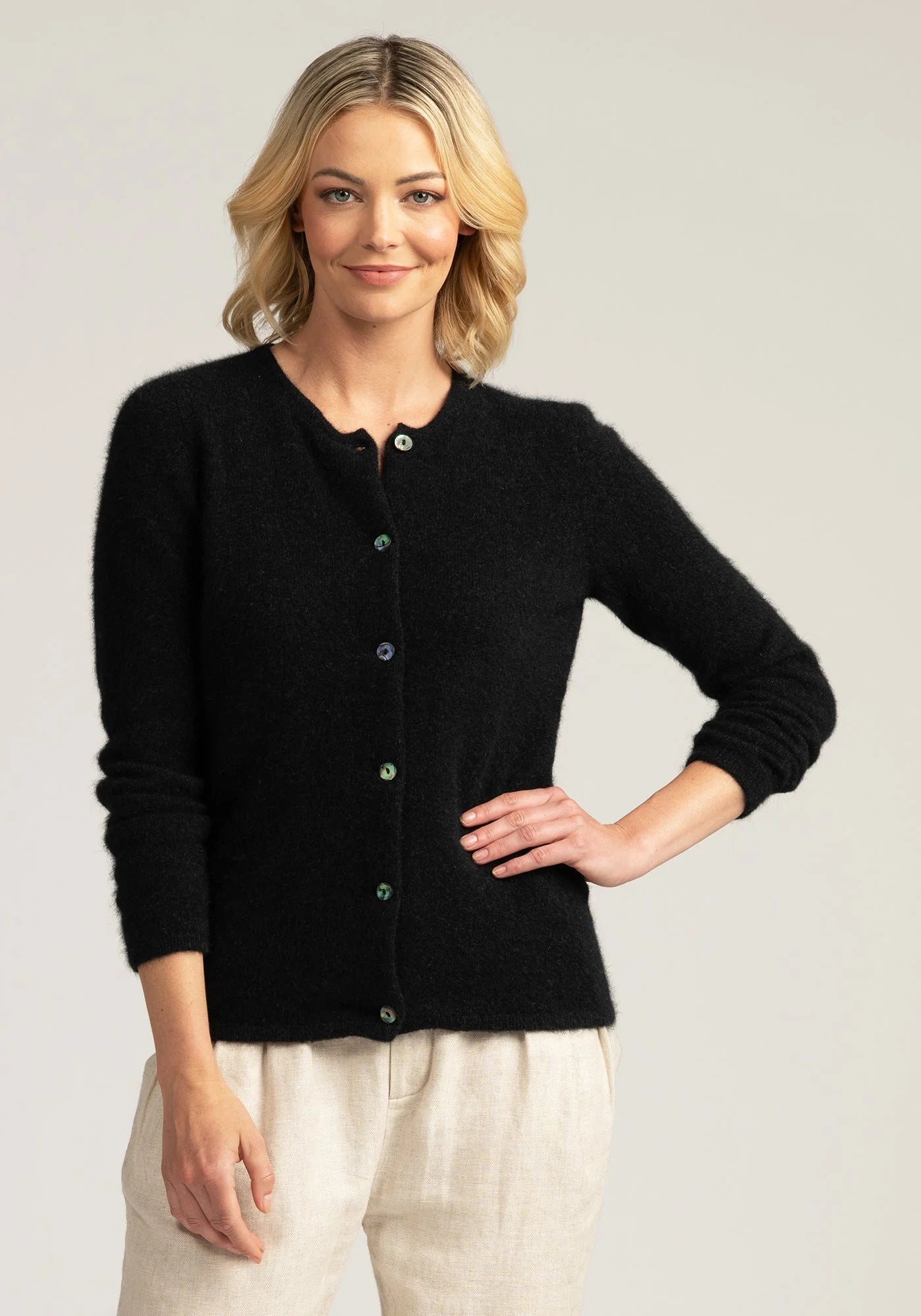 "Discover the perfect blend of comfort and class in our black merino wool cardigan. Button up for timeless style."