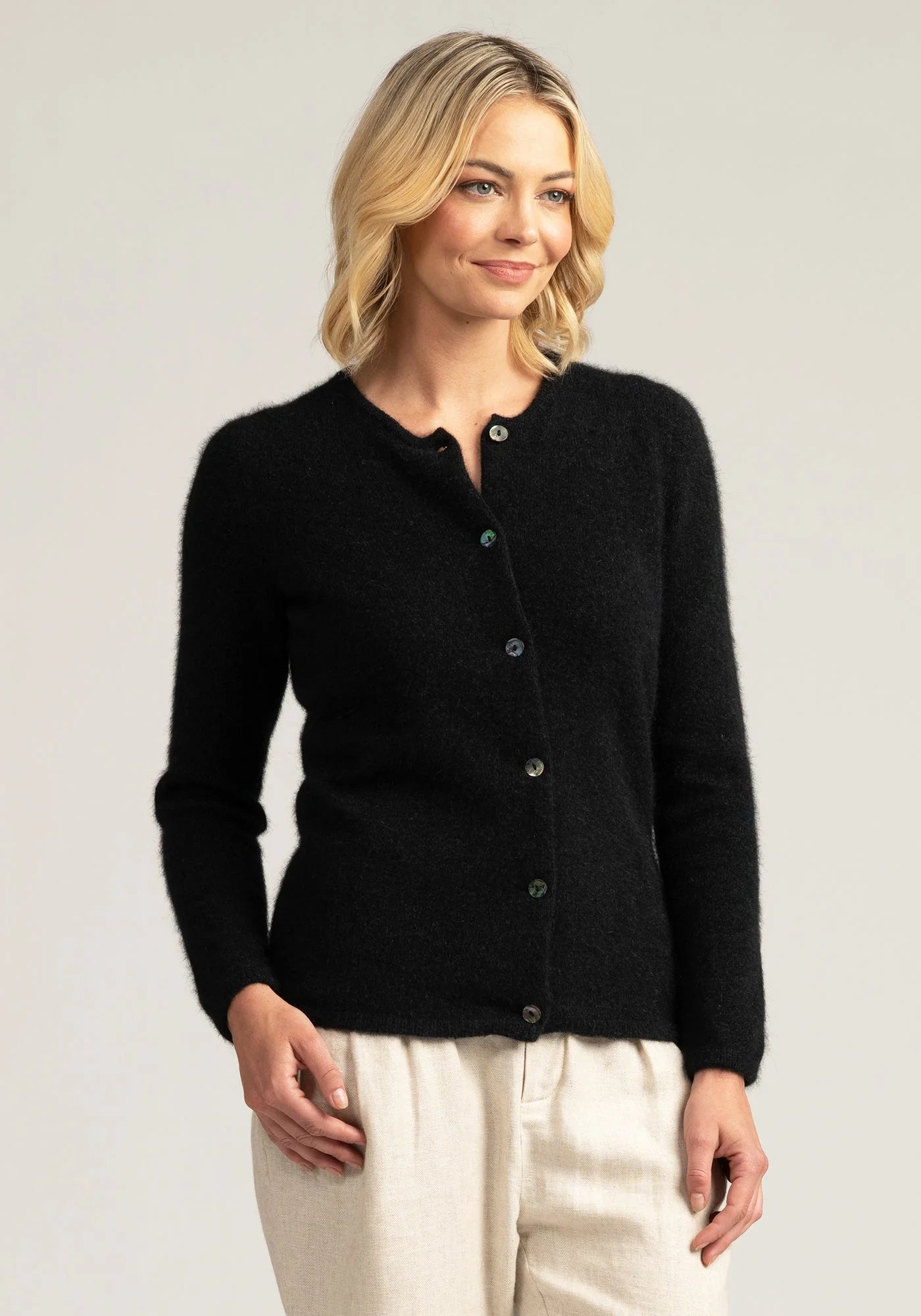 "Wrap yourself in luxury with our black merino wool button-up cardigan. Effortless chic for any occasion."