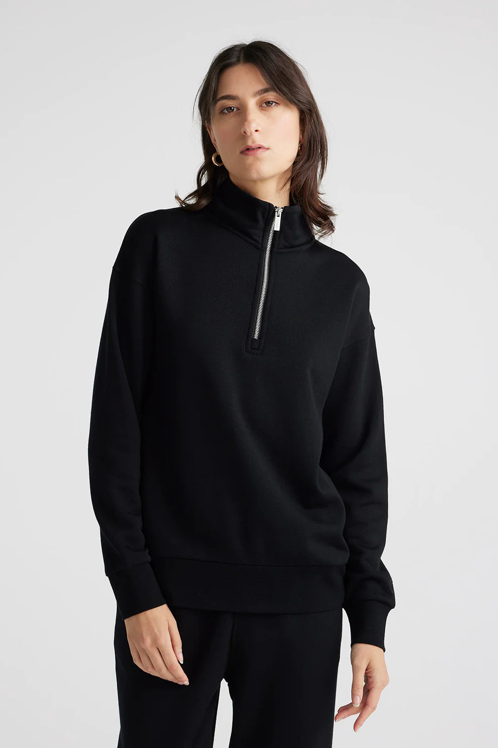 Elevate your wardrobe with our sleek black Merino wool zip sweater. Effortlessly chic, irresistibly comfortable