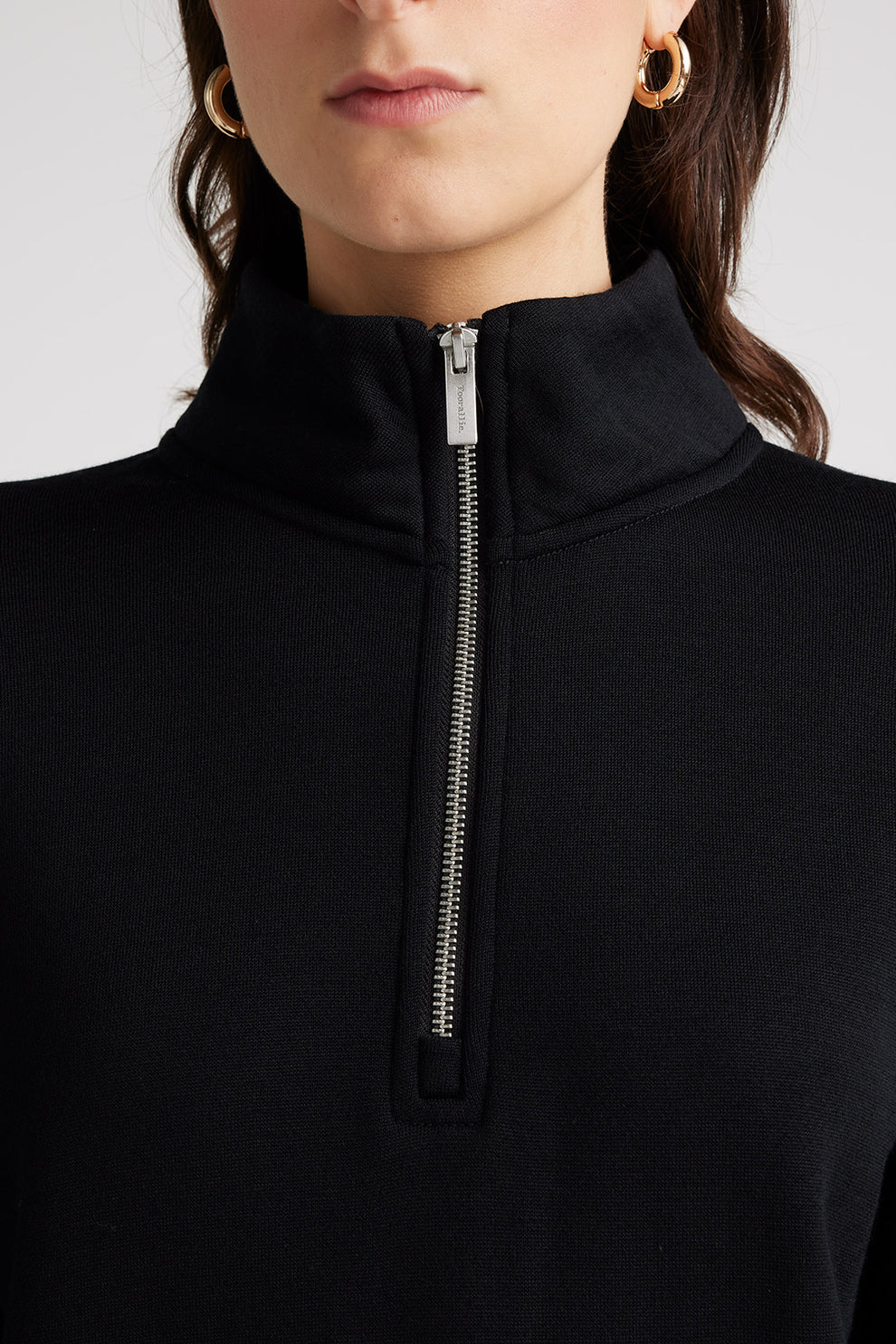 "Wrap yourself in warmth and sophistication with our black Merino wool zip collar sweater. Timeless elegance awaits."
