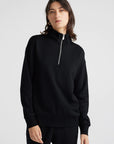 Elevate your wardrobe with our sleek black Merino wool zip sweater. Effortlessly chic, irresistibly comfortable