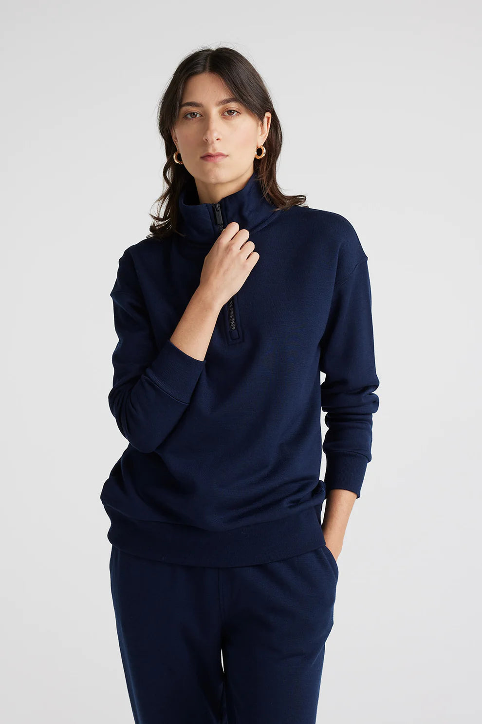 "Elevate your wardrobe with our navy Merino wool sweater. Zip collar adds a modern twist to classic elegance