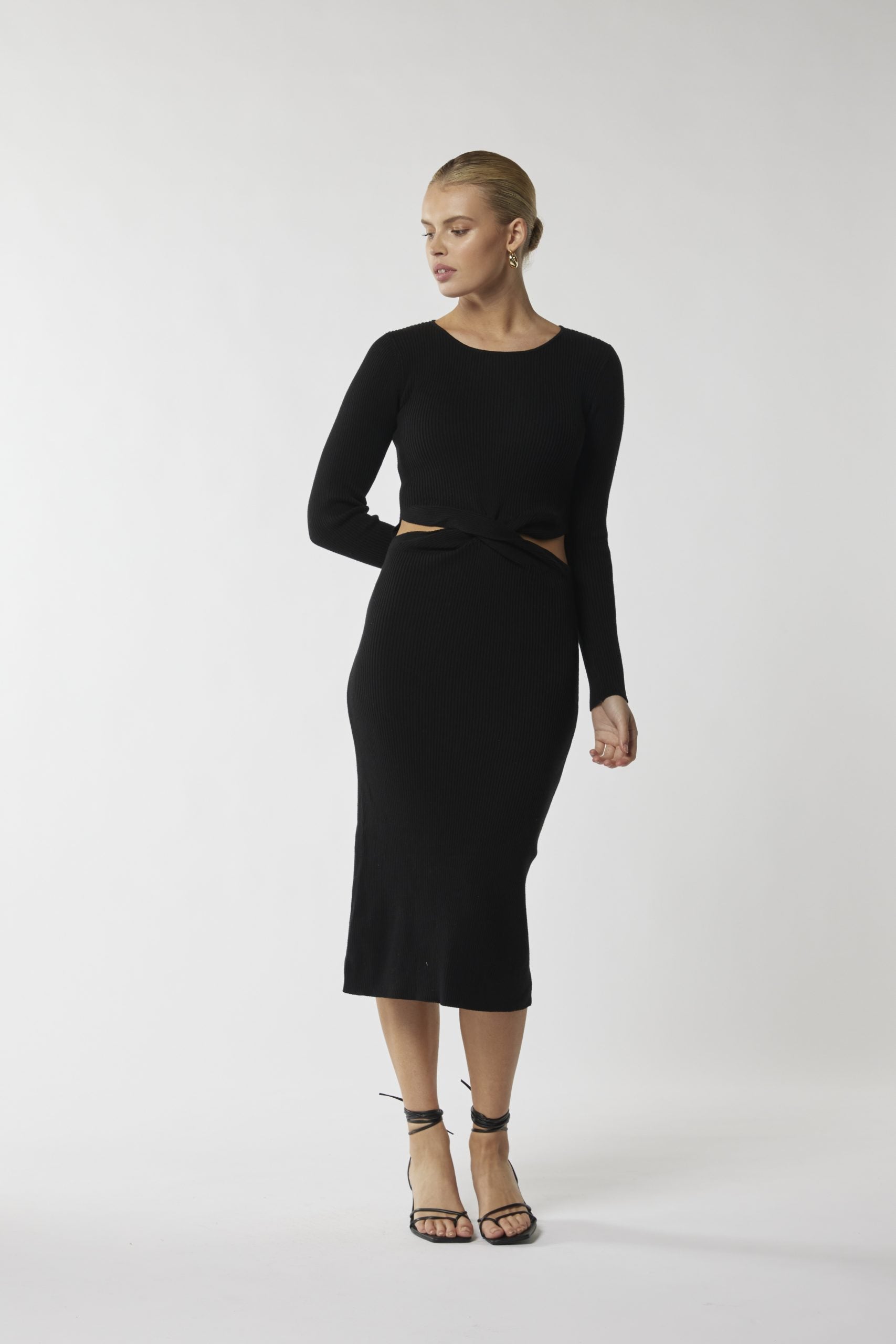 "Embrace timeless style with our black midi dress featuring a flattering cut-out waist. Shop now!"