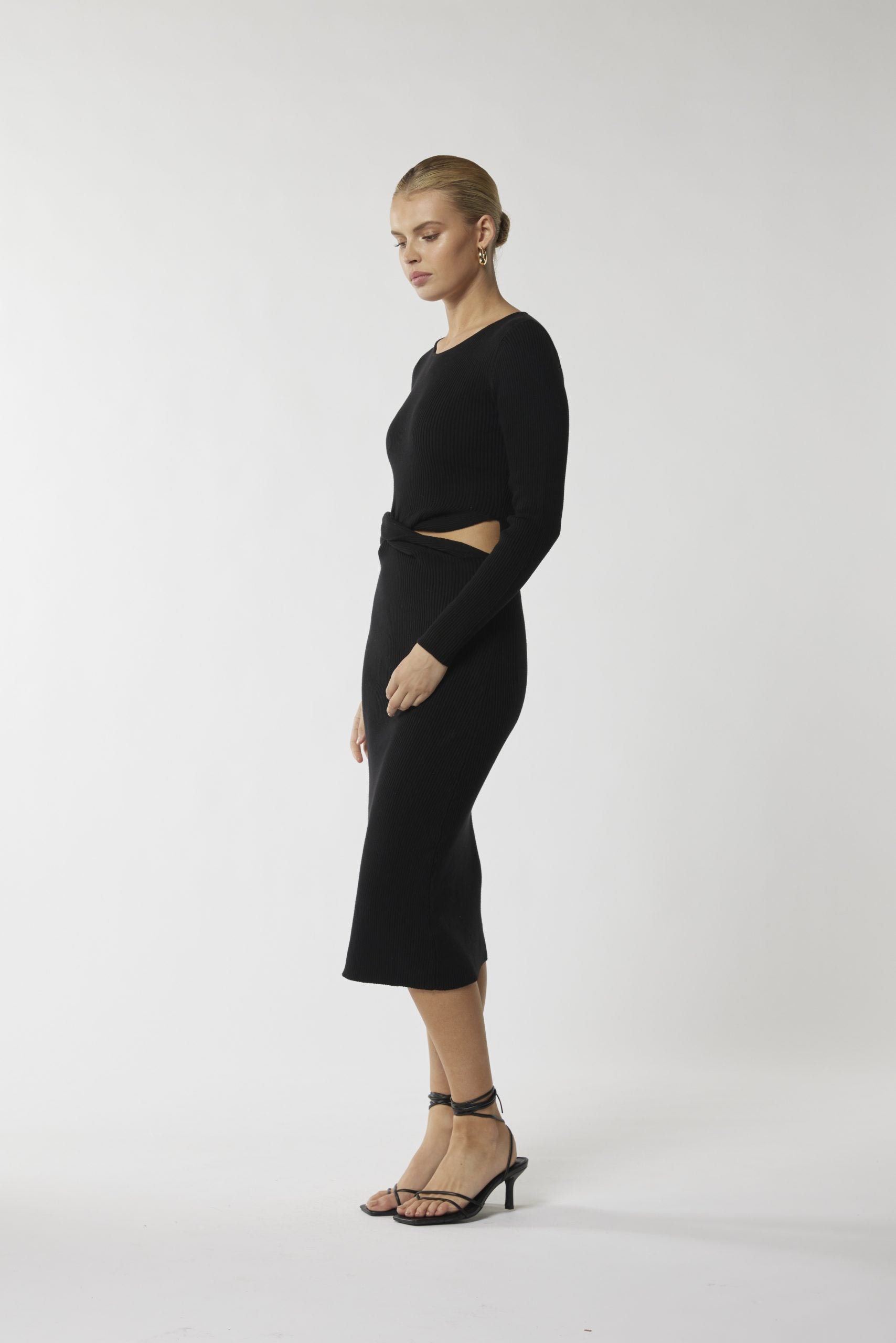 "Discover elegance in every detail with our cut-out waist black midi dress. Elevate your style today!"