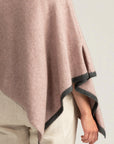 Elevate your wardrobe with our light pink merino wool poncho. Effortless elegance in every stitch. Buy now!