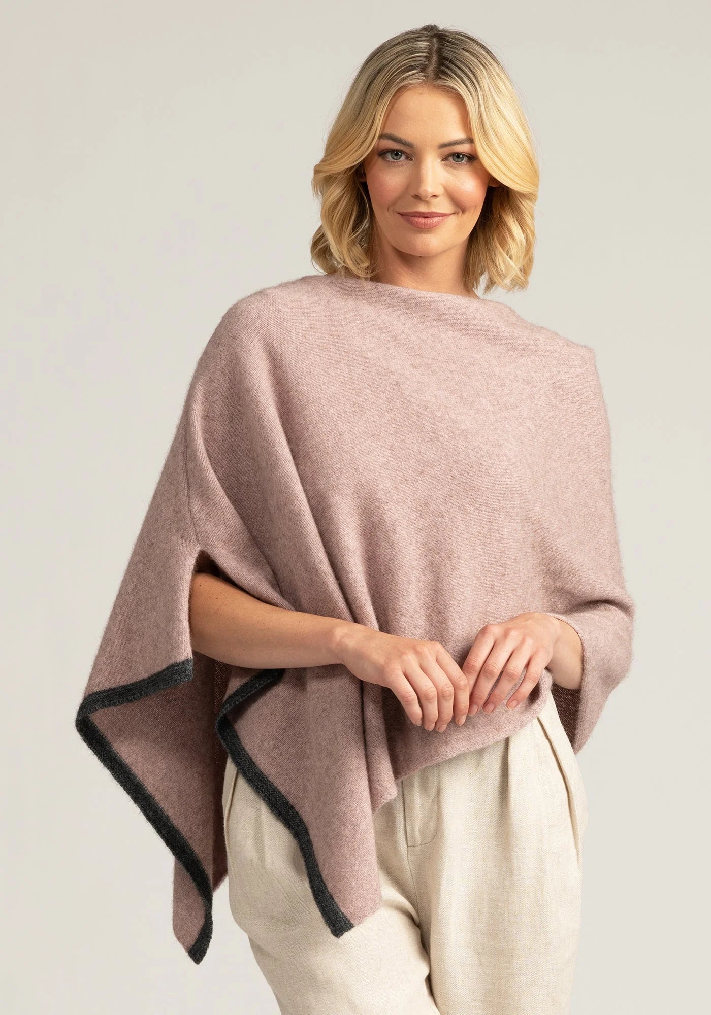 Experience pure comfort in our light pink merino wool poncho. Stay warm, stay fashionable. Shop now!