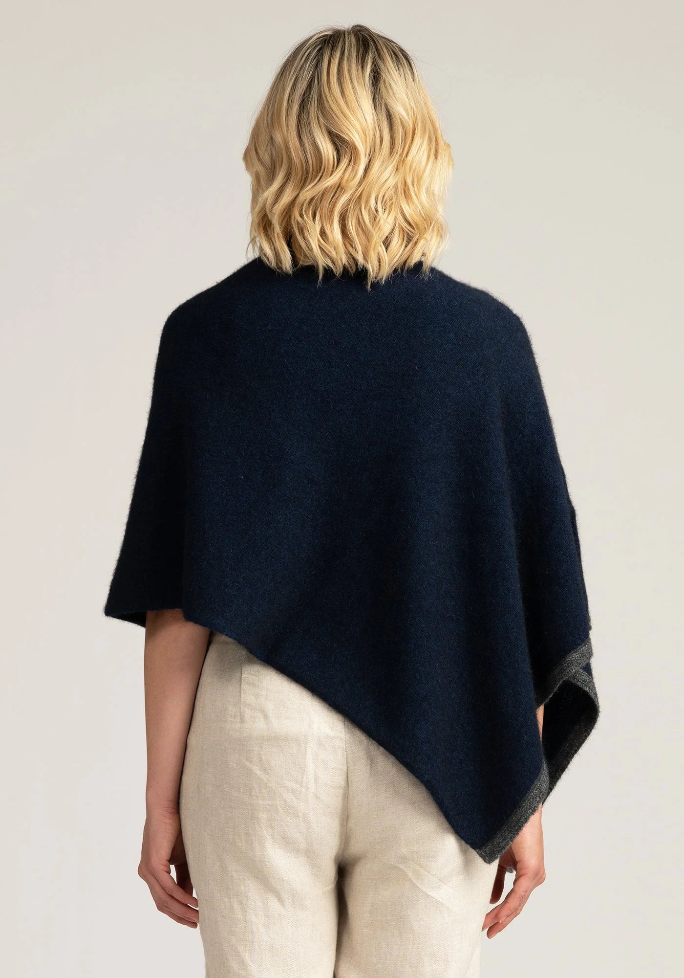 Wrap yourself in comfort with our navy blue merino wool poncho. Effortless chic for any occasion. Get yours today!