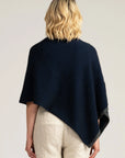 Wrap yourself in comfort with our navy blue merino wool poncho. Effortless chic for any occasion. Get yours today!