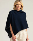 Experience the luxury of merino wool in our navy blue poncho. Stay snug and stylish all season long. Order now!