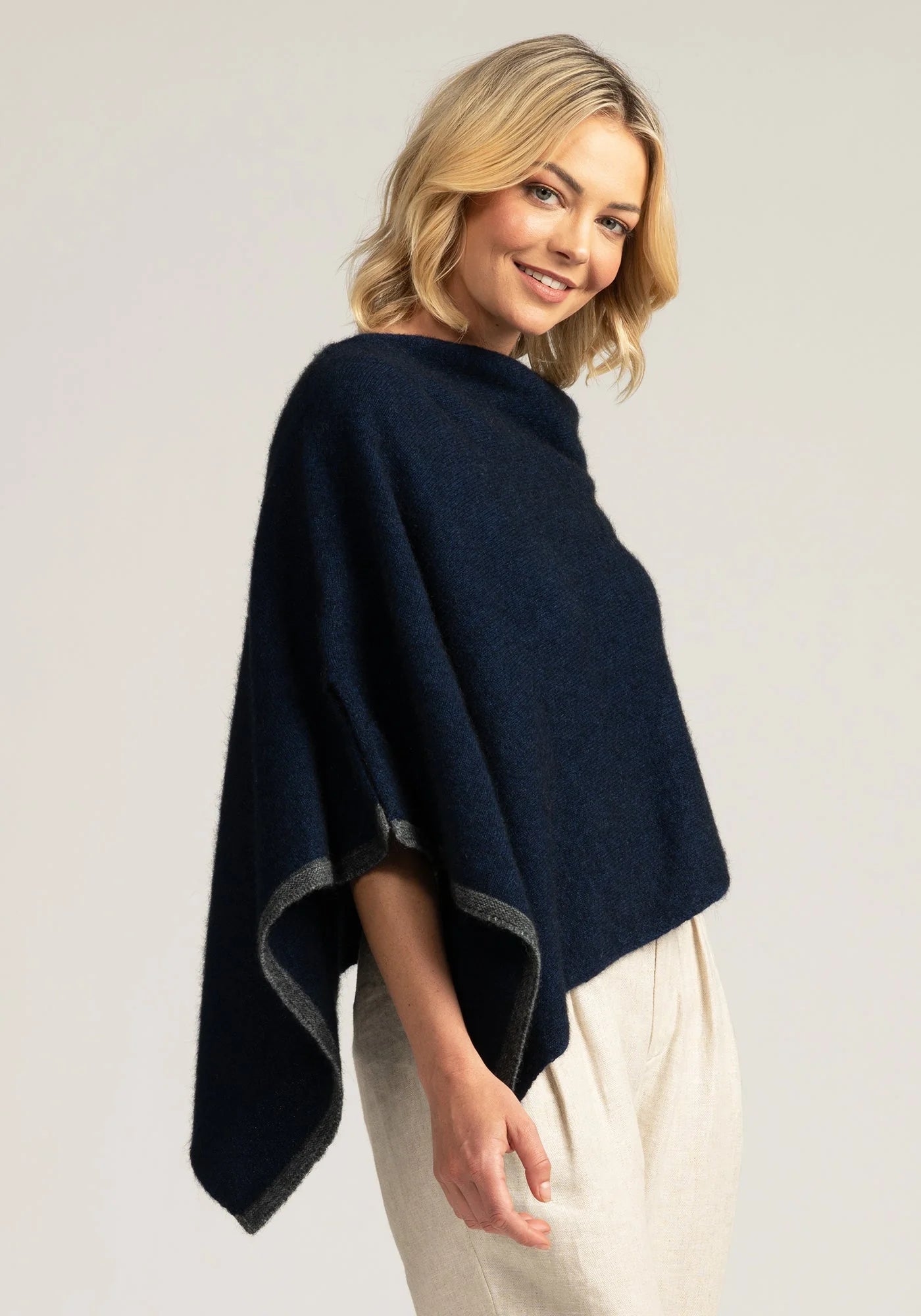 Stay cozy in style with our navy blue merino wool poncho. Luxurious warmth meets timeless elegance. Shop now!