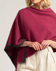 Wrap yourself in luxury with our Pink Merino Wool Poncho. Effortlessly chic and cozy, perfect for any occasion!