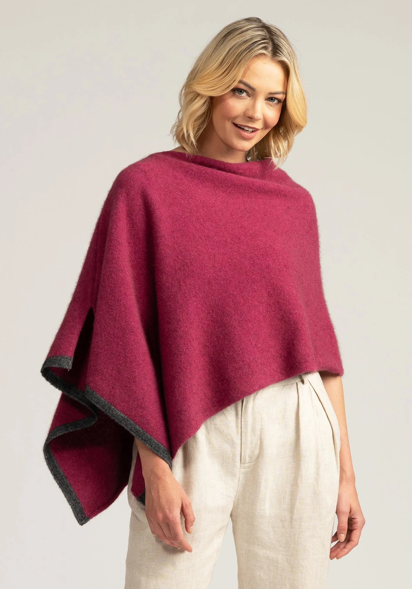Wrap yourself in luxury with our Pink Merino Wool Poncho with grey trim. Effortless elegance in every stitch. Shop now!