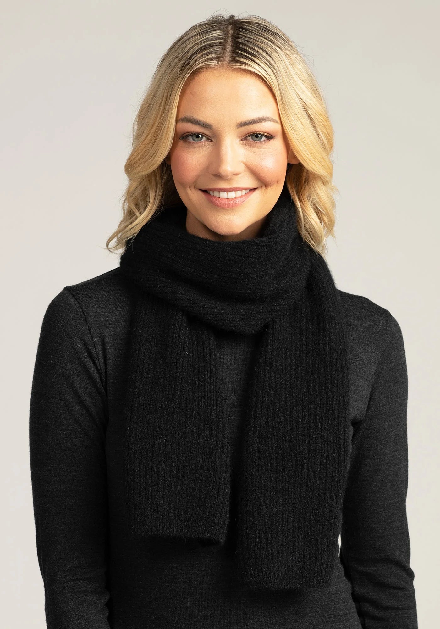 Complete your winter look with our black merino wool ribbed scarf. Luxurious warmth for any occasion.