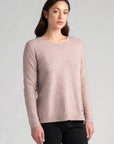 "Wrap yourself in luxury with our light blush pink merino wool sweater. Effortless elegance awaits."