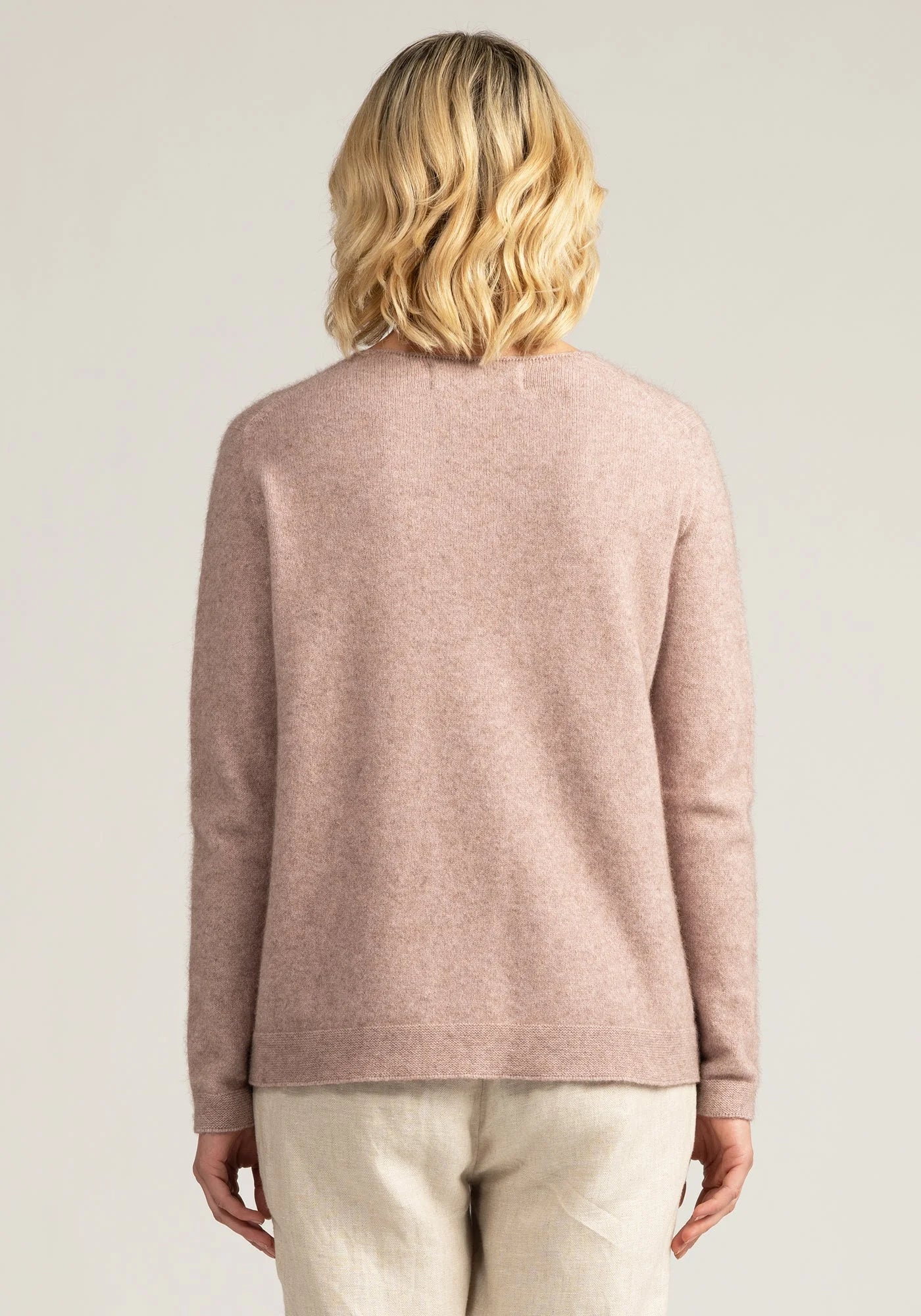"Indulge in warmth and sophistication with our blush pink merino wool sweater. Shop the look today!"