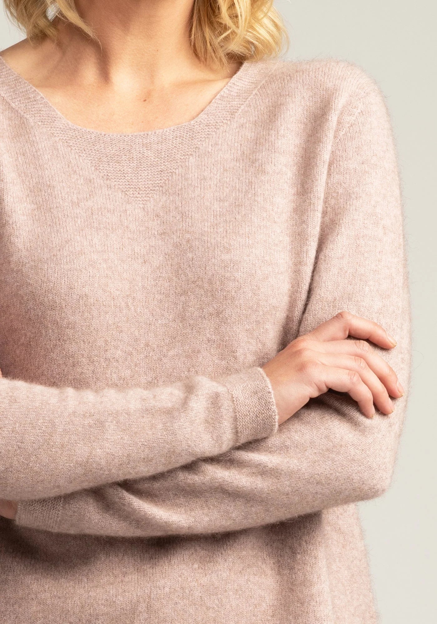 "Discover the allure of blush pink in our merino wool sweater. Comfort meets couture in every stitch."