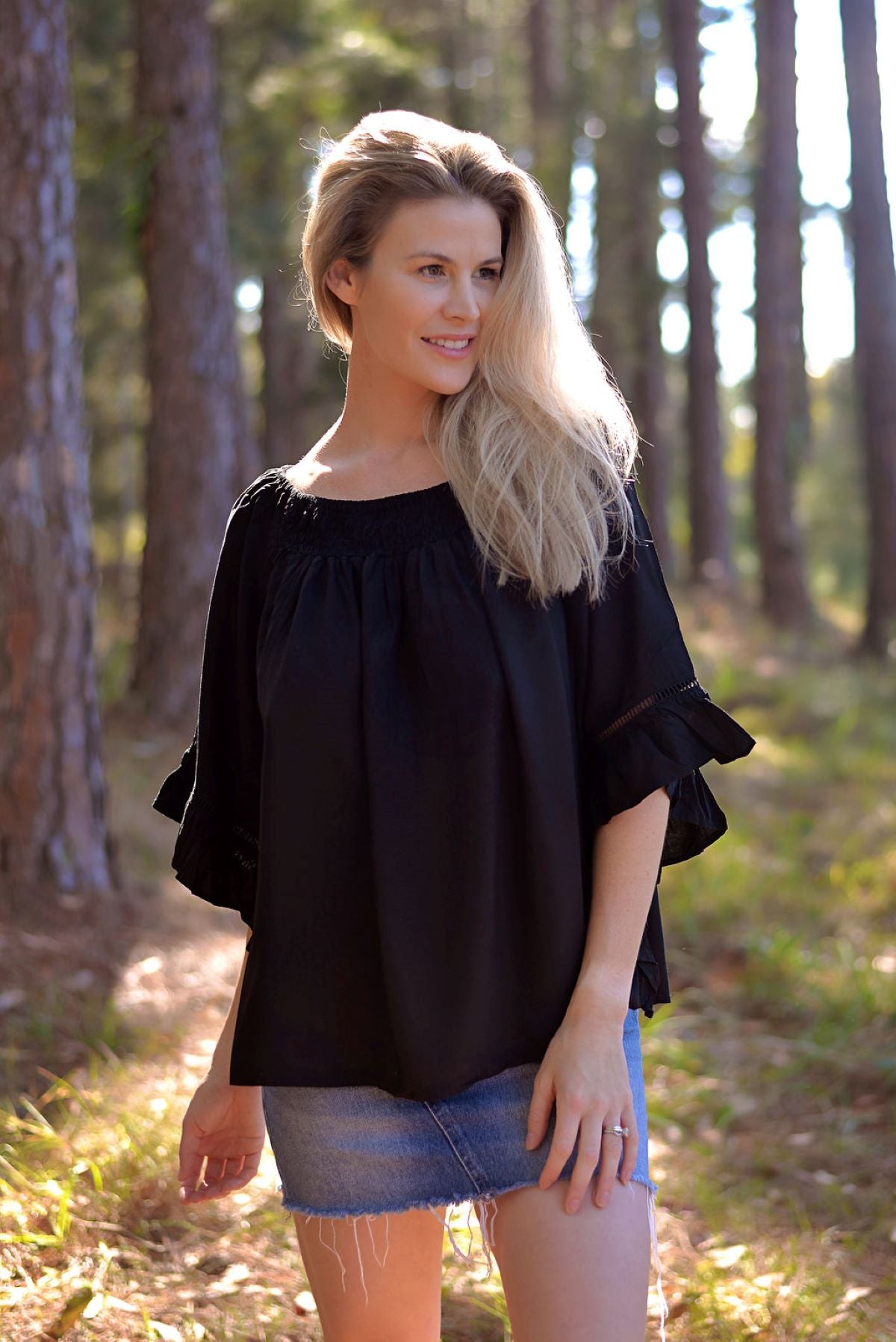 Elevate your style with our chic off-shoulder black top. Perfect for any occasion, this trendy piece adds a touch of elegance to your wardrobe. Shop now!