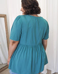 Turn heads in teal! Our plus-size babydoll top celebrates every curve. Comfortable, stylish, and irresistible. Buy yours now!