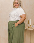 Flatter your curves with our vibrant green wide-leg pants for plus sizes. Embrace style and comfort effortlessly! Shop now.