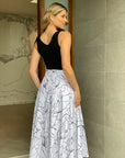 Embrace sophistication in our white maxi skirt, adorned with playful scribble print. Your wardrobe essential awaits!